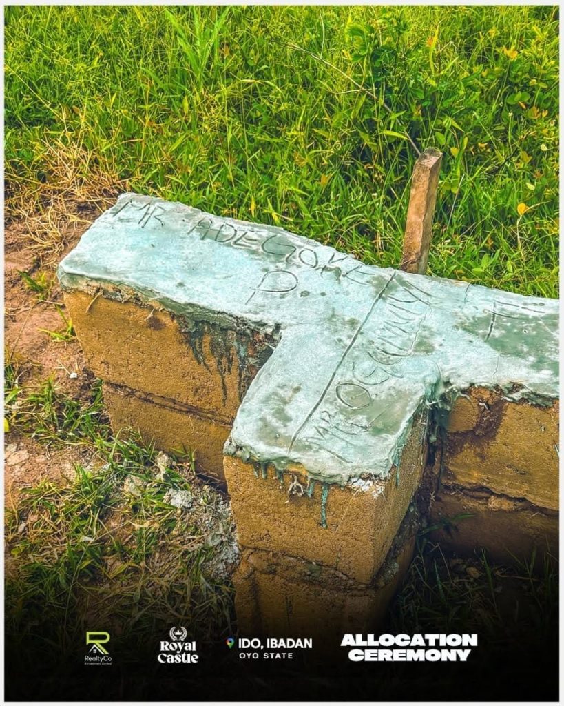 Concrete boundary marker inscribed with plot allocation details at the Royal Castle land site in Ido, Ibadan