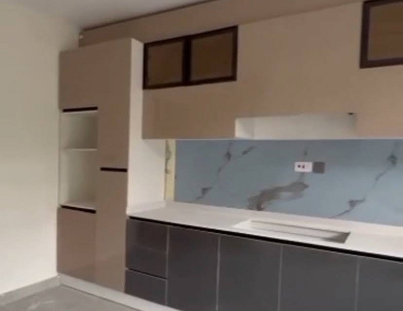 Legacy Citadel Oasis, Ajah — fitted kitchen with marble-effect splashback and stone worktop