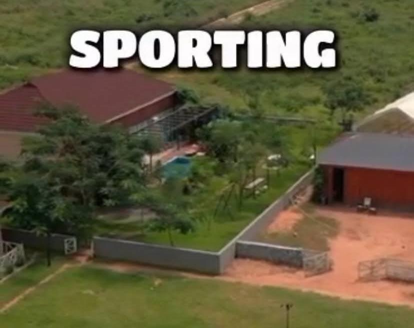 Aerial view of a nearby developed estate with pool and sporting facilities near Legacy Hill City